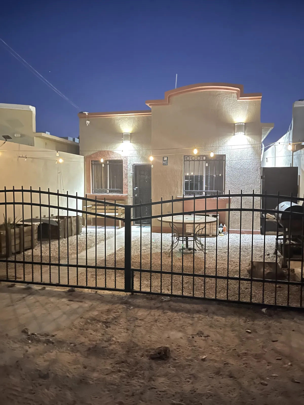 Private Oceanfront Beach House - gated courtyard at night